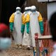Health workers in protective gear start their shift at an Ebola treatment center in Beni, Congo DRC.